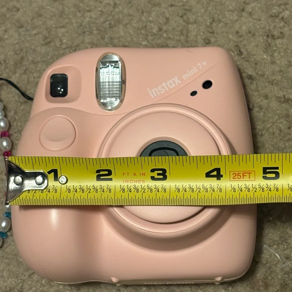NWOT instax mini 7+ pink camera with a beaded lanyard (uses 4 AA batteries)